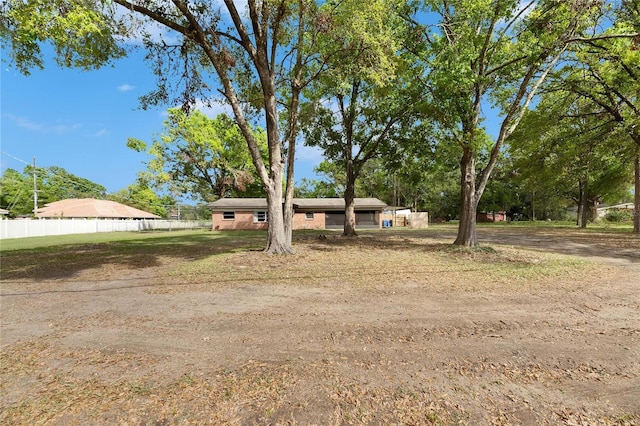 ranch-style home with fence