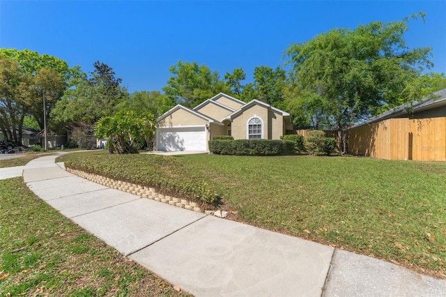 ranch-style home featuring fence, driveway, an attached garage, stucco siding, and a front lawn