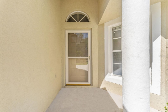 view of exterior entry with stucco siding