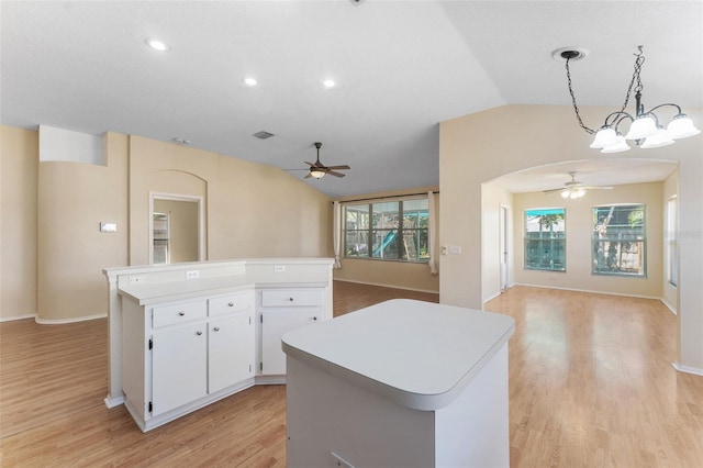 kitchen with open floor plan, a kitchen island, and ceiling fan