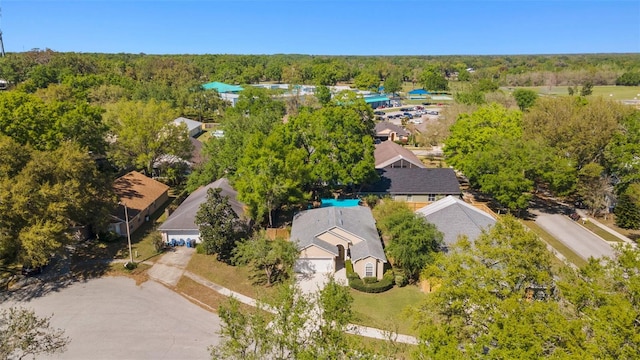 drone / aerial view featuring a wooded view