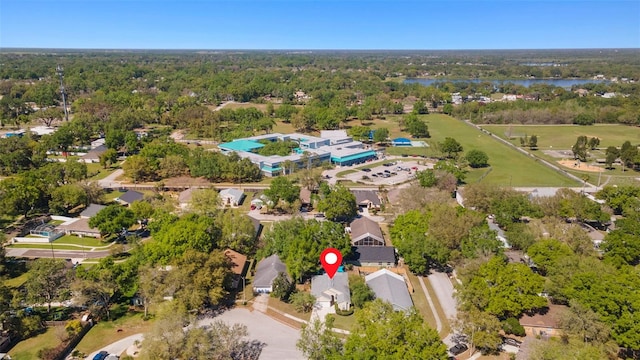 bird's eye view featuring a residential view, a wooded view, and a water view