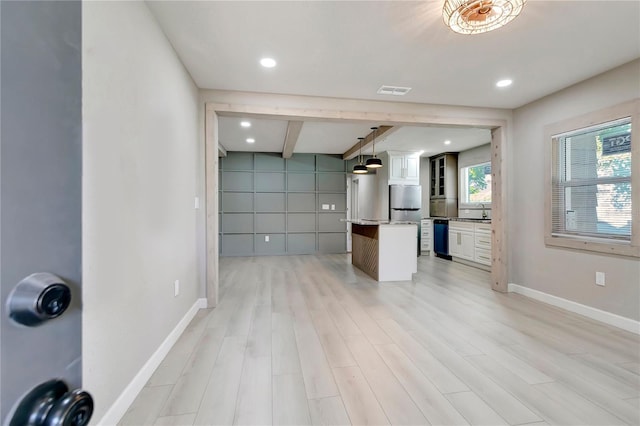 interior space with recessed lighting, light wood-style floors, baseboards, and a sink