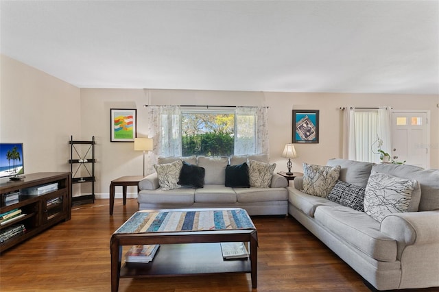 living area featuring dark wood finished floors and baseboards