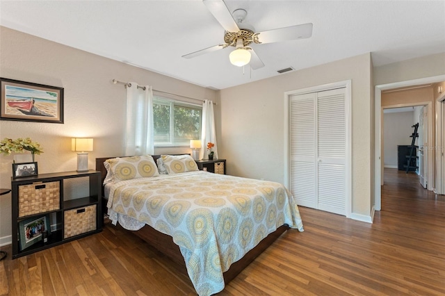 bedroom featuring a closet, visible vents, baseboards, and wood finished floors