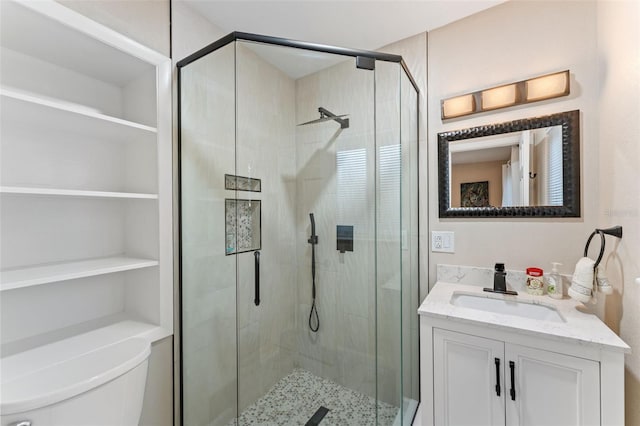 bathroom featuring vanity, toilet, and a stall shower