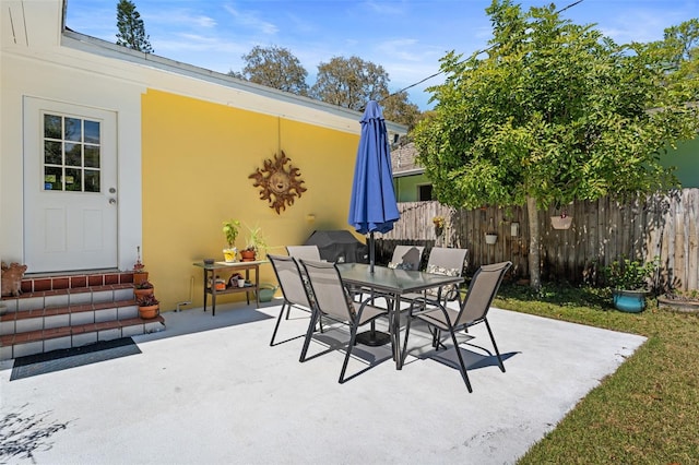 view of patio / terrace with outdoor dining space and fence