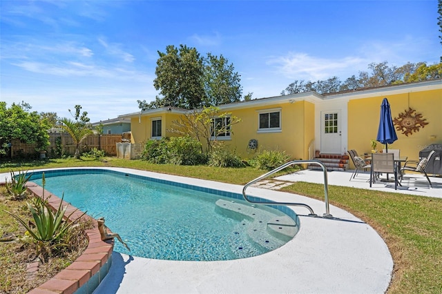 view of pool with a fenced in pool, a patio area, and fence