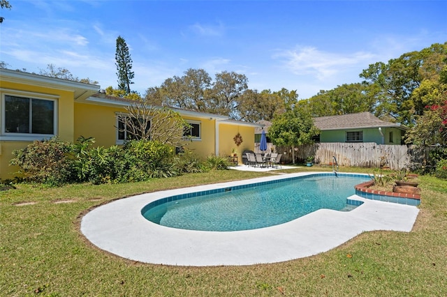 view of pool featuring a patio area, a fenced in pool, fence, and a lawn