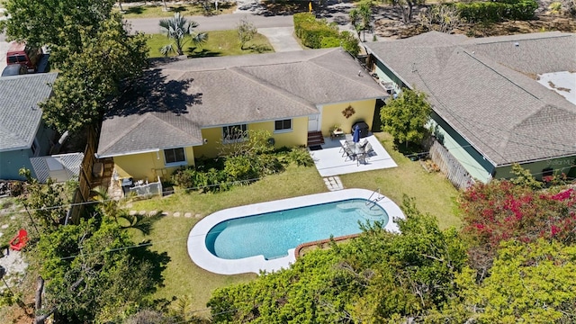 pool with a patio, a yard, and a fenced backyard