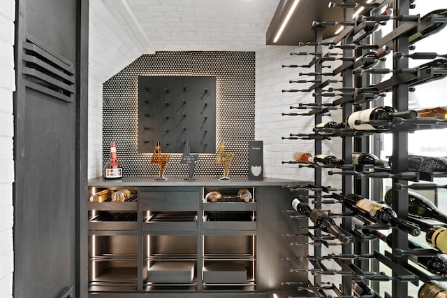 wine room featuring brick wall