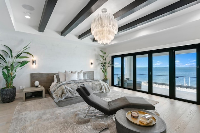 bedroom with access to exterior, a notable chandelier, wood finished floors, and beam ceiling