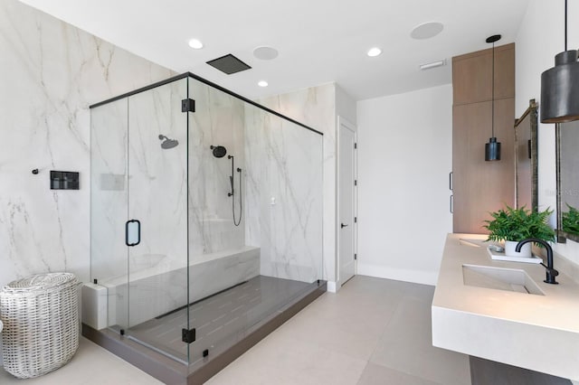 bathroom featuring baseboards, visible vents, a marble finish shower, recessed lighting, and a sink