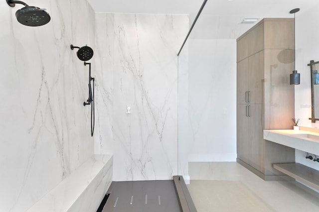 bathroom with visible vents and a marble finish shower