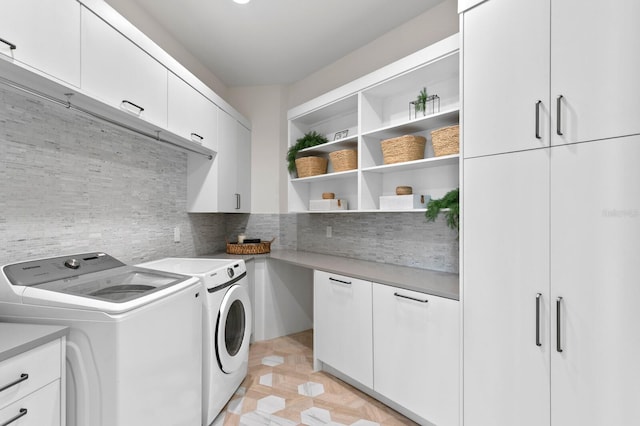 laundry area with washing machine and dryer and cabinet space