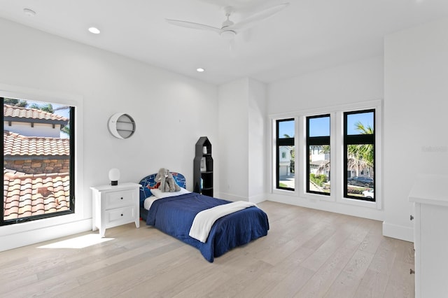 bedroom featuring recessed lighting, multiple windows, baseboards, and light wood-style floors