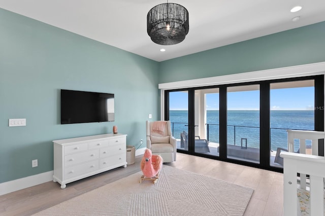 interior space featuring recessed lighting, baseboards, light wood-style floors, and access to outside