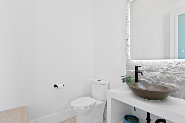 half bathroom featuring toilet and vanity