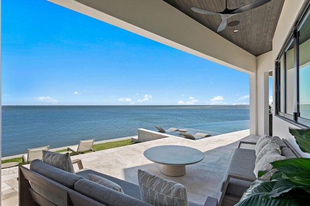 view of patio / terrace with an outdoor living space, a water view, and ceiling fan