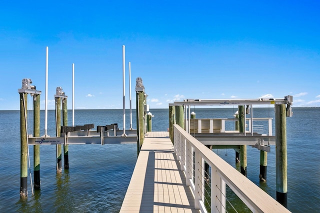 dock area with a water view and boat lift