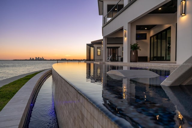 view of dock with a water view and a balcony