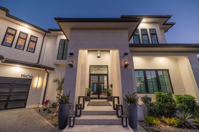 view of front of property with stucco siding and french doors