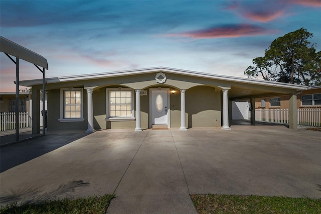 view of front of property with fence and stucco siding