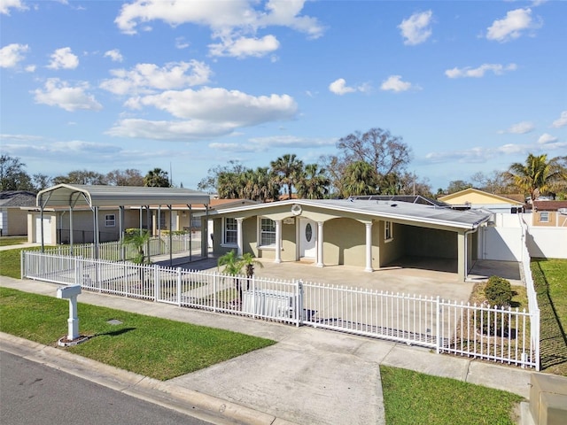 view of front of house with an attached carport, a gate, driveway, and a fenced front yard