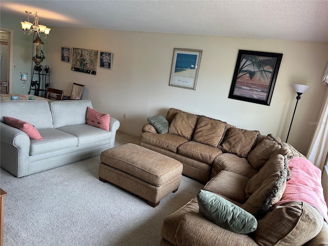 living room featuring a notable chandelier, carpet, and a textured ceiling