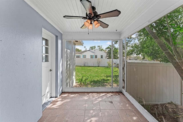 unfurnished sunroom with wood ceiling and ceiling fan