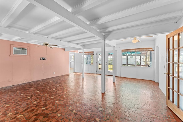 unfurnished room with beamed ceiling, a ceiling fan, and a wall unit AC