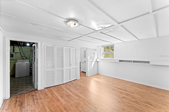 empty room with washer / clothes dryer and light wood-style floors