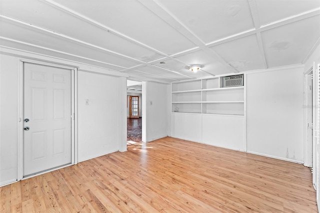 unfurnished bedroom with a wall mounted AC and light wood-style floors