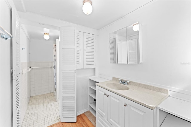 bathroom with a shower with curtain, wood finished floors, and vanity