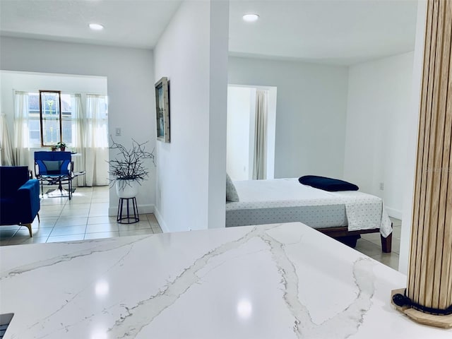bedroom with light tile patterned floors, recessed lighting, and baseboards