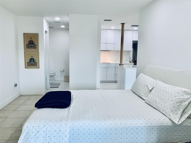 bedroom featuring visible vents, connected bathroom, baseboards, light tile patterned floors, and recessed lighting