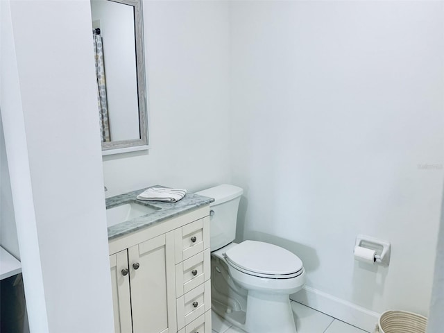 bathroom featuring vanity, toilet, and baseboards