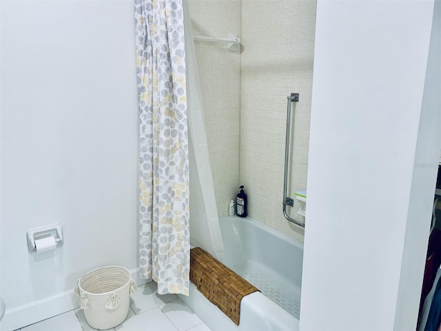 bathroom with tile patterned flooring, shower / bath combination with curtain, and baseboards