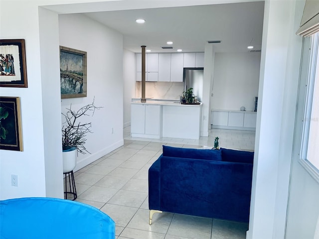 living area featuring visible vents, light tile patterned floors, recessed lighting, and baseboards
