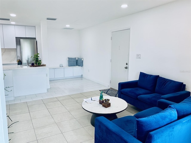 living room featuring light tile patterned floors, recessed lighting, and visible vents
