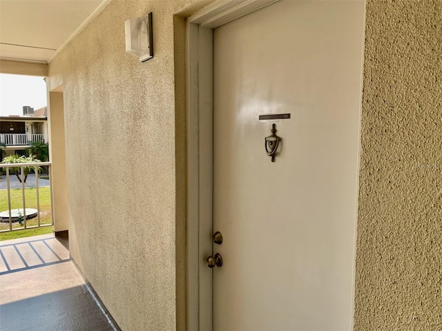 entrance to property with stucco siding