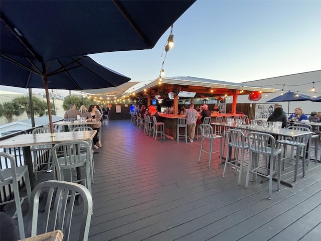 dock area featuring outdoor dry bar, outdoor dining space, and a wooden deck