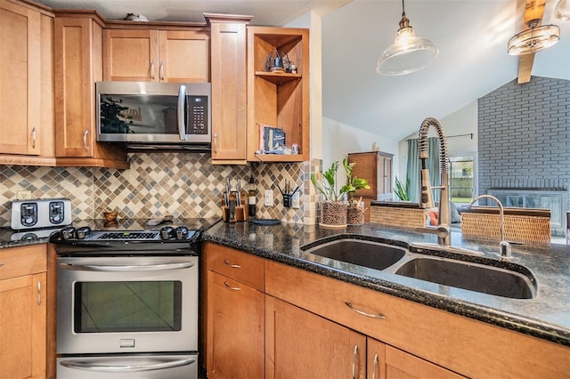 kitchen featuring a sink, lofted ceiling with beams, stainless steel appliances, dark stone counters, and decorative backsplash