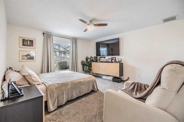 bedroom featuring visible vents, ceiling fan, and carpet