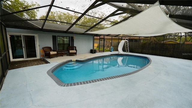 view of swimming pool featuring a fenced in pool, a patio, a water slide, and a lanai