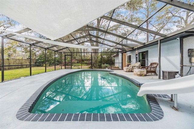 view of swimming pool with glass enclosure, a patio, and a water slide