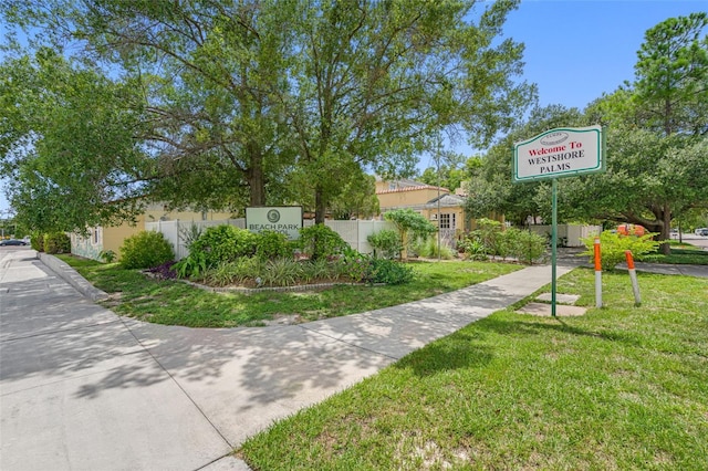 view of property's community with a yard and fence