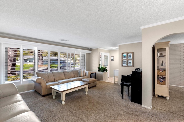 living area featuring visible vents, a textured ceiling, crown molding, and carpet