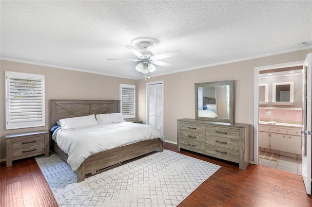 bedroom with hardwood / wood-style flooring, a closet, ensuite bathroom, a textured ceiling, and crown molding