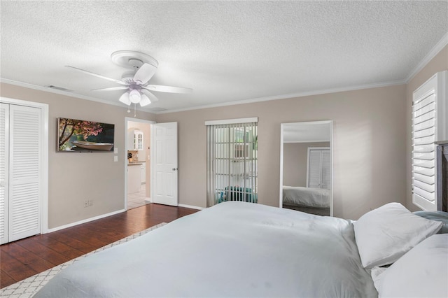 bedroom featuring hardwood / wood-style flooring, multiple windows, crown molding, and visible vents